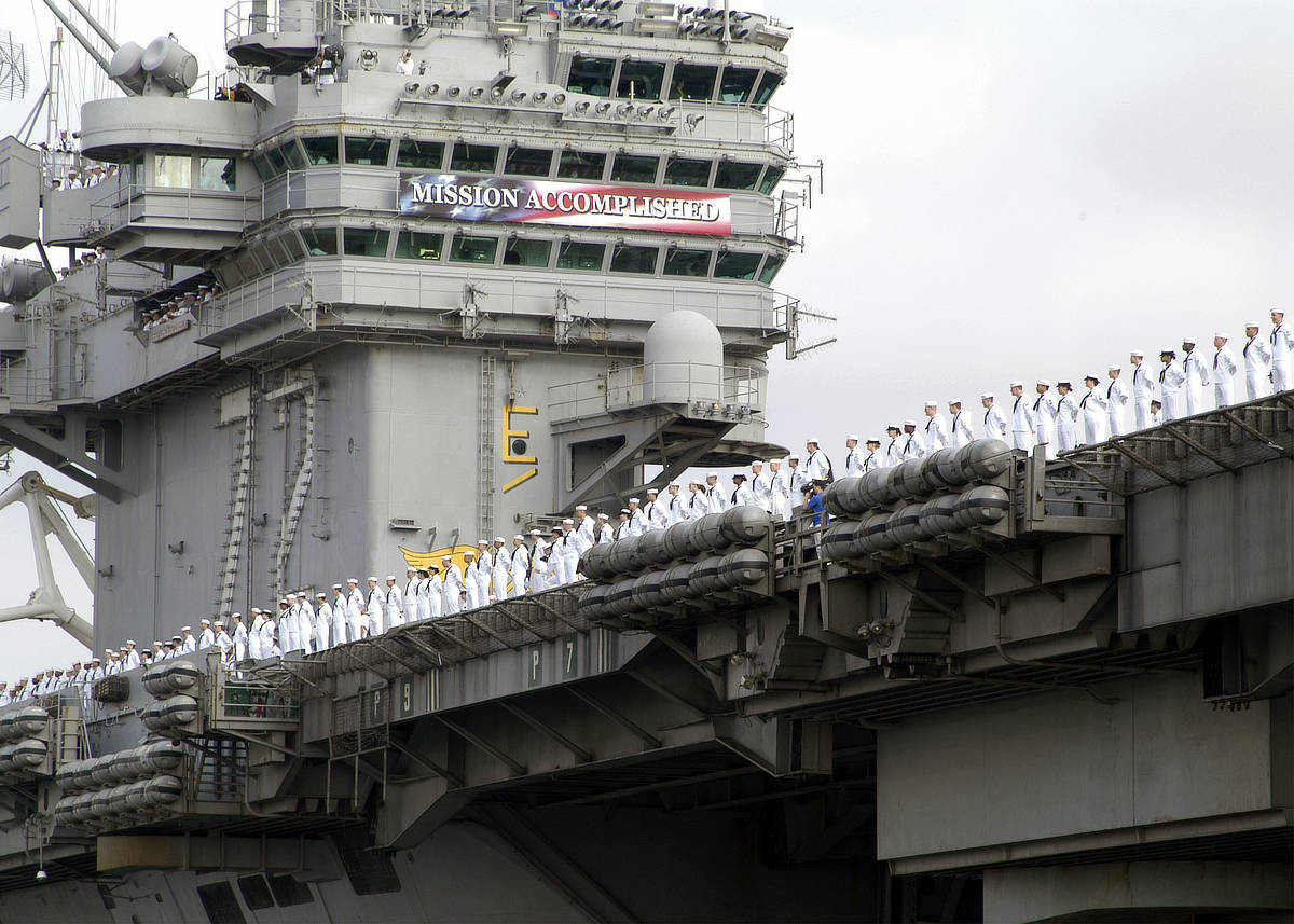 The USS Abraham Lincoln returning to port carrying the Mission Accomplished banner